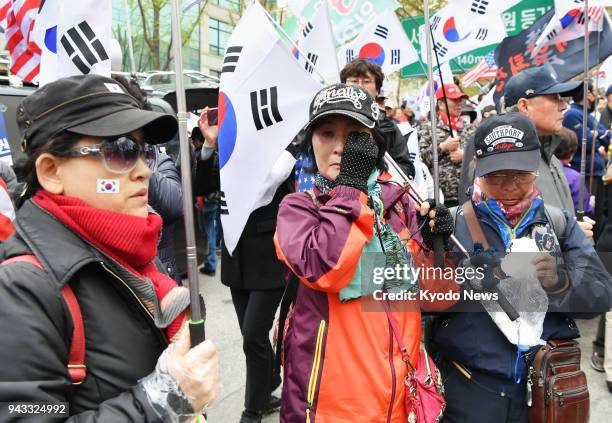 Supporters of South Korea's ousted President Park Geun Hye stage a rally near the Seoul Central District Court on April 6 when Park was sentenced to...