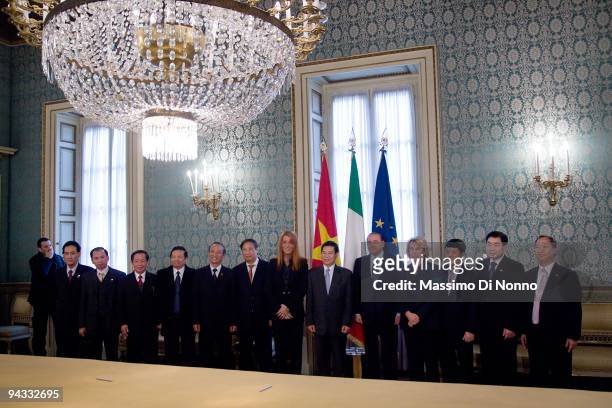 Italian Prime Minister Silvio Berlusconi and Vietnamese President Nguyen Minh Triet pose with their delegations on December 11, 2009 in Milan, Italy....