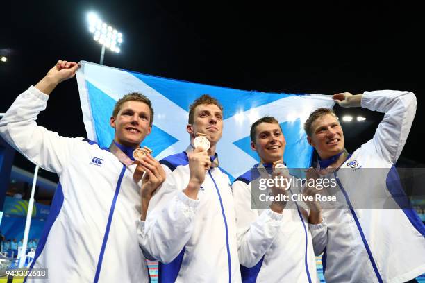 Bronze medalists Stephen Milne, Duncan Scott, Daniel Wallace and Mark Szaranek of Scotland pose during the medal ceremony for the Men's 4 x 200m...