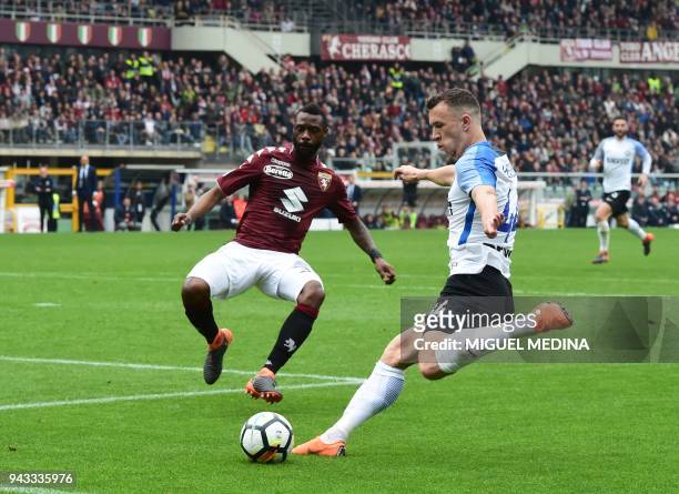 Inter Milan's Croatian forward Ivan Perisic vies with Torino's Cameroon defender Nicolas Nkoulou during the Italian Serie A football match Torino FC...
