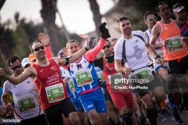 Athletes run in Piazza Venezia Square after the start of the Rome City Marathon, Sundathe XXIV edition of the Rome Marathon, on April 8, 2018 in...