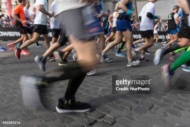 Athletes run in Piazza Venezia Square after the start of the Rome City Marathon, Sundathe XXIV edition of the Rome Marathon, on April 8, 2018 in...
