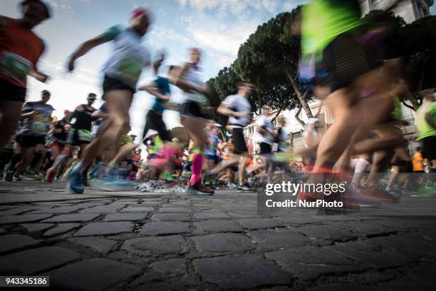 Athletes run in Piazza Venezia Square after the start of the Rome City Marathon, Sundathe XXIV edition of the Rome Marathon, on April 8, 2018 in...