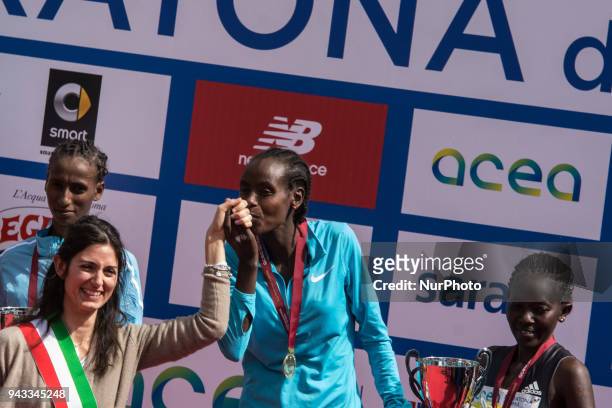 Rahma Tusa from Ethiopia, winner, Dalila Abdulkadir Gosa , second, and Kenya's Alice Jepkemboi Kibor , third, pose on the podium with the mayor of...