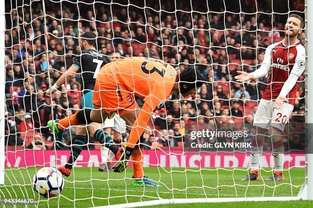 Arsenal's German defender Shkodran Mustafi reacts as Southampton's Irish striker Shane Long scores the opening goal past Arsenal's Czech goalkeeper...