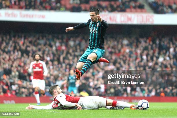 Shkodran Mustafi of Arsenal and Dusan Tadic of Southampton in action during the Premier League match between Arsenal and Southampton at Emirates...