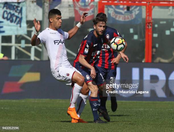 Andrea Barberis of Crotone competes for the ball with Erick Pulgar of Bologna during the serie A match between FC Crotone and Bologna FC at Stadio...