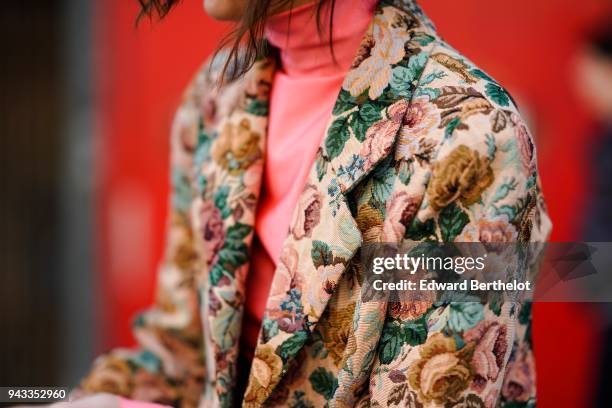 Guest wears a flower print blazer jacket, a pink turtleneck top, during London Fashion Week February 2018 on February 16, 2018 in London, England.