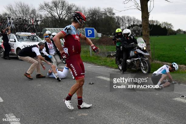 Germany's Tony Martin reacts as Norway's Alexander Kristoff lies on the ground after a crash during the 116th edition of the Paris-Roubaix one-day...
