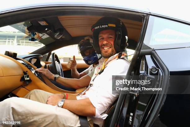 Peter Phillips prepares to be driven by David Coulthard in an Aston Martin Vanquish S as part of F1 Hotlaps before the Bahrain Formula One Grand Prix...