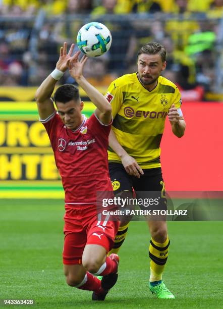 Dortmund's German defender Marcel Schmelzer and Stuttgart's German midfielder Erik Thommy vie for the ball during the German first division...