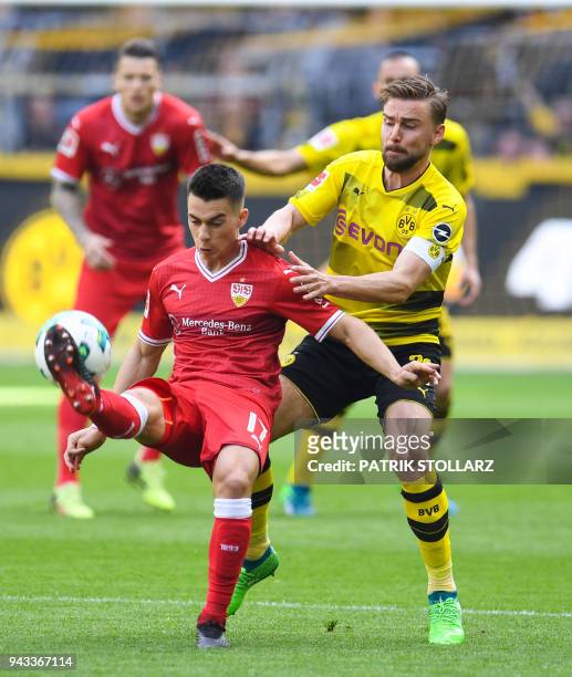 Dortmund's German defender Marcel Schmelzer and Stuttgart's German midfielder Erik Thommy vie for the ball during the German first division...