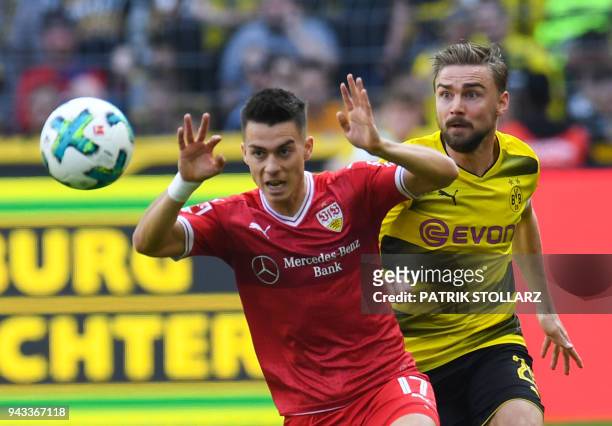 Dortmund's German defender Marcel Schmelzer and Stuttgart's German midfielder Erik Thommy vie for the ball during the German first division...