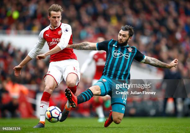 Rob Holding of Arsenal and Charlie Austin of Southampton battle for possession during the Premier League match between Arsenal and Southampton at...