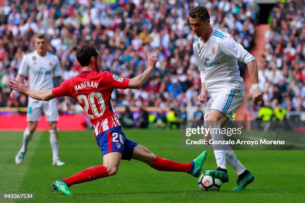 Cristiano Ronaldo of Real Madrid CF competes for the ball with Juan Francisco Torres alias Juanfran of Atletico de Madrid during the La Liga match...