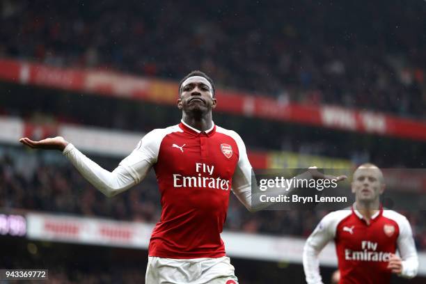 Danny Welbeck of Arsenal celebrates with team mate Jack Wilshere after scoring his sides third goal during the Premier League match between Arsenal...