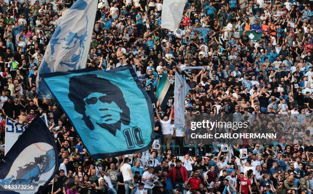 Napoli's fans cheer during the Italian Serie A football match SSC Napoli vs AC Chievo Verona on April 8, 2018 at the San Paolo Stadium in Naples.