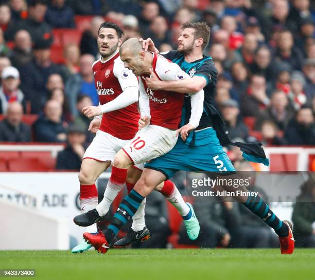 Jack Stephens of Southampton clashes with Jack Wilshere of Arsenal which later leads to Jack Stephens of Southampton being shown a red card during...