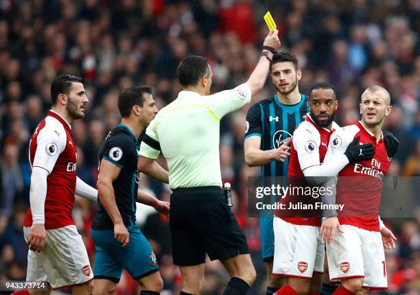 Jack Wilshere of Arsenal is shown a yellow card by referee Andre Marriner during the Premier League match between Arsenal and Southampton at Emirates...