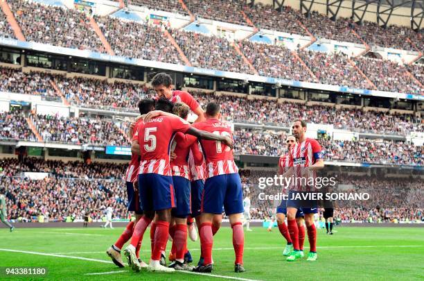 Atletico Madrid players celebrate a goal during the Spanish league football match between Real Madrid CF and Club Atletico de Madrid at the Santiago...