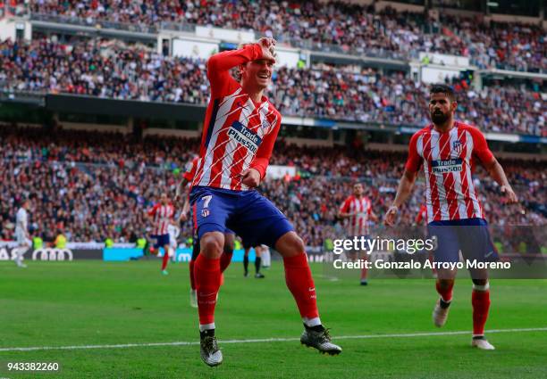 Antoine Griezmann of Atletico de Madrid celebrates scoring their opening goal with teammate Diego Costa during the La Liga match between Real Madrid...