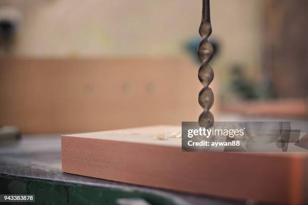 metal drill bit makes a hole in the wood - rotary blade stock pictures, royalty-free photos & images