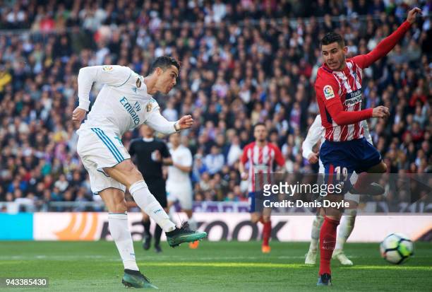 Cristiano Ronaldo of Real Madrid scores his team's first goal past Lucas Hernandez of Atletico de Madrid during the La Liga match between Real Madrid...