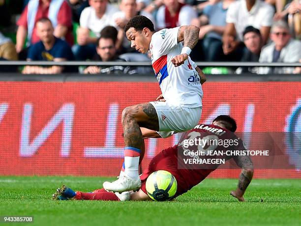 Metz's French defender Julian Palmieri vies for the ball with Lyon's Dutch forward Memphis Depay during the French L1 football match between Metz and...