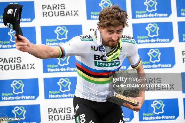 Winner Slovakia's Peter Sagan celebrates with his trophy on the podium after the 116th edition of the Paris-Roubaix one-day classic cycling race,...