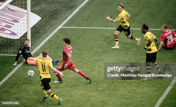 Maximilian Philipp of Dortmund scores his team's third goal past goalkeeper Ron-Robert Zieler of Stuttgart during the Bundesliga match between...