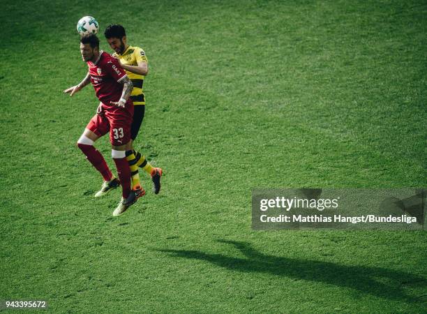 Daniel Ginczek of Stuttgart jumps for a header with Nuri Sahin of Dortmund during the Bundesliga match between Borussia Dortmund and VfB Stuttgart at...