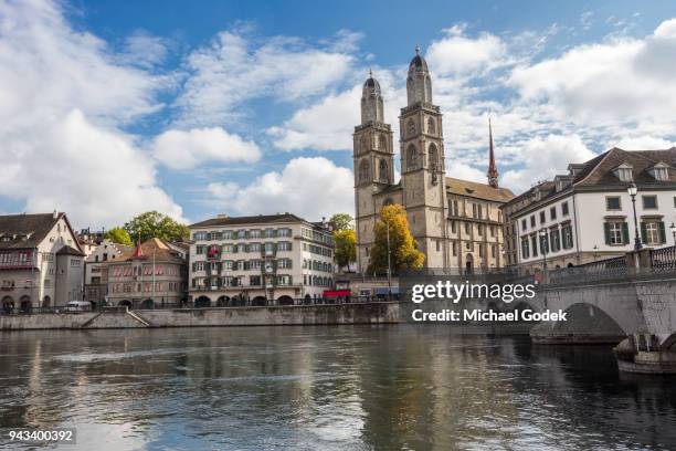 beautiful view of grossmünster church from across the limmat river in zurich - grossmünster stock-fotos und bilder
