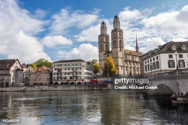 beautiful view of grossmünster church from across the limmat river in zurich - grossmunster cathedral stock pictures, royalty-free photos & images