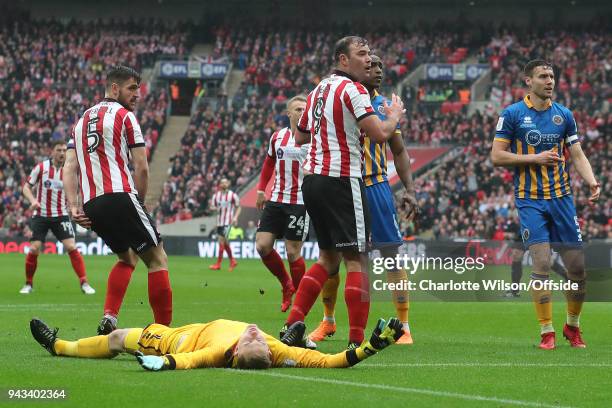 Players look round towards the open goal as Shrewsbury goalkeeper Dean Henderson lies unconscious during the Checkatrade Trophy Final between Lincoln...