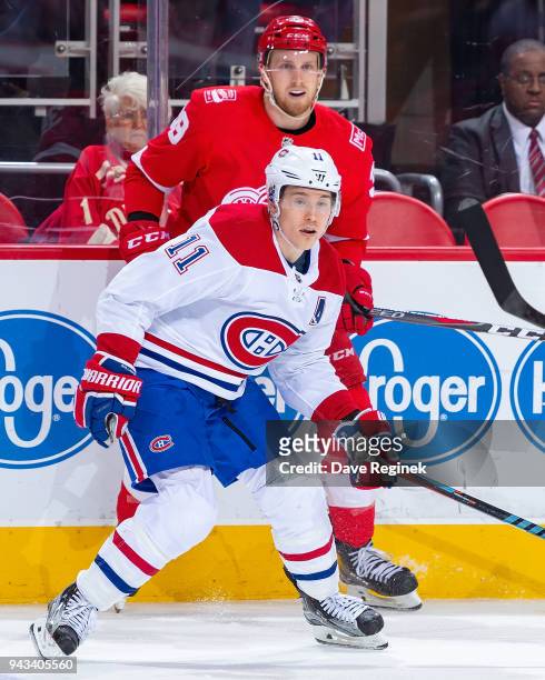 Brendan Gallagher of the Montreal Canadiens skates in front of Anthony Mantha of the Detroit Red Wings during an NHL game at Little Caesars Arena on...