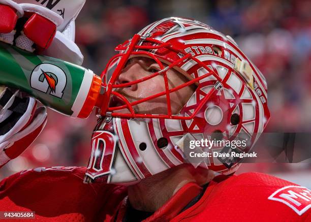 Jared Coreau of the Detroit Red Wings gets a drink of water at the bench on a play stoppage during an NHL game against the Montreal Canadiens at...