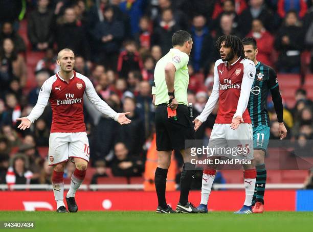 Referee Andre Marriner shows the red card to Mohamed Elneny of Arsenal during the Premier League match between Arsenal and Southampton at Emirates...