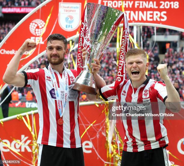 Luke Waterfall and goalscorer Elliot Whitehouse of Lincoln celebrate with the trophy during the Checkatrade Trophy Final between Lincoln City and...