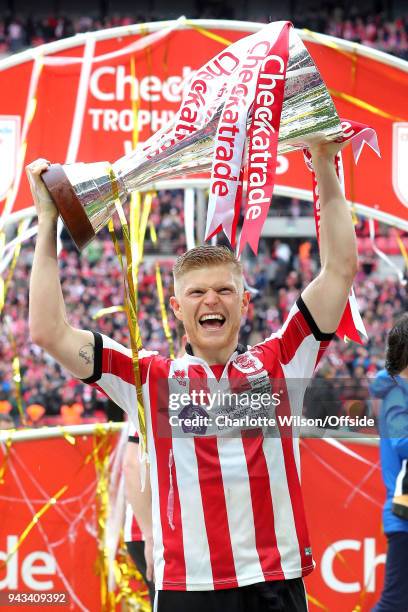 Goalscorer Elliot Whitehouse of Lincoln celebrates with the trophy during the Checkatrade Trophy Final between Lincoln City and Shrewsbury Town at...