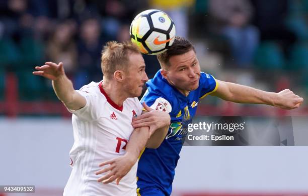 Vladislav Ignatyev of FC Lokomotiv Moscow and Aleksandr Sapeta of FC Rostov Rostov-on-Don vie for the ball during the Russian Football League match...