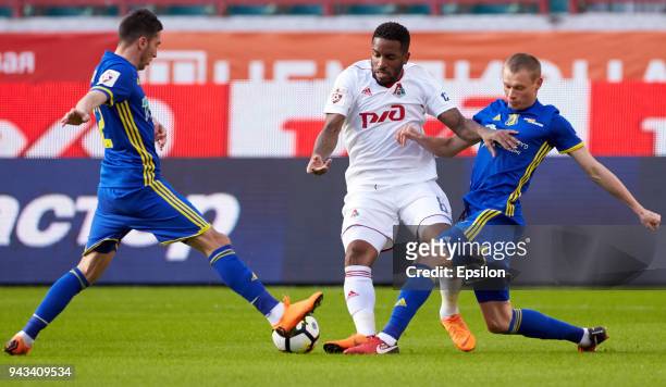 Jefferson Farfan of FC Lokomotiv Moscow vie for the ball with Aleksei Ionov and Yevgeni Makeyev of FC Rostov Rostov-on-Don during the Russian...