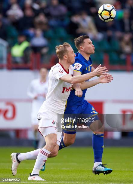 Vladislav Ignatyev of FC Lokomotiv Moscow and Aleksandr Sapeta of FC Rostov Rostov-on-Don vie for the ball during the Russian Football League match...