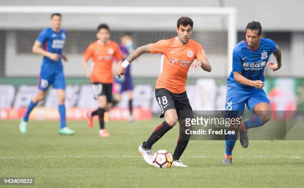 Augusto Fernandez of Beijing Renhe and Fredy Guarin of Shanghai Shenhua in action during teh 2018 Chinese Super League match between Beijing Renhe...