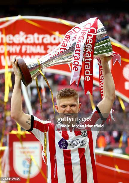 Elliot Whitehouse of Lincoln lifts the trophy after victory during the Checkatrade Trophy Final between Shrewsbury Town and Lincoln City at Wembley...