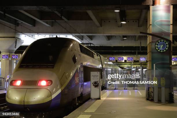 An high speed TGV train stands at a platform on April 8, 2018 at the Gare Montparnasse train station in Paris as French rail workers launched their...