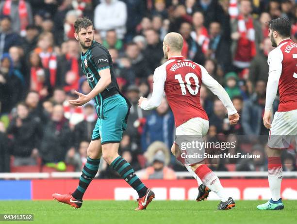 Jack Wilshere of Arsenal clashes with Jack Stephens of Southampton during the Premier League match between Arsenal and Southampton at Emirates...