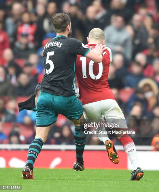 Jack Wilshere of Arsenal clashes with Jack Stephens of Southampton during the Premier League match between Arsenal and Southampton at Emirates...