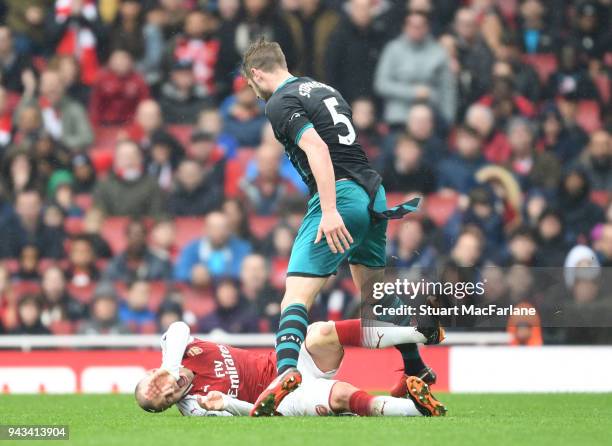 Jack Wilshere of Arsenal clashes with Jack Stephens of Southampton during the Premier League match between Arsenal and Southampton at Emirates...