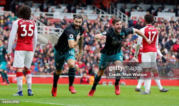 Charlie Austin and Jack Stephens of Southampton celebrate during the Premier League match between Arsenal and Southampton at Emirates Stadium on...