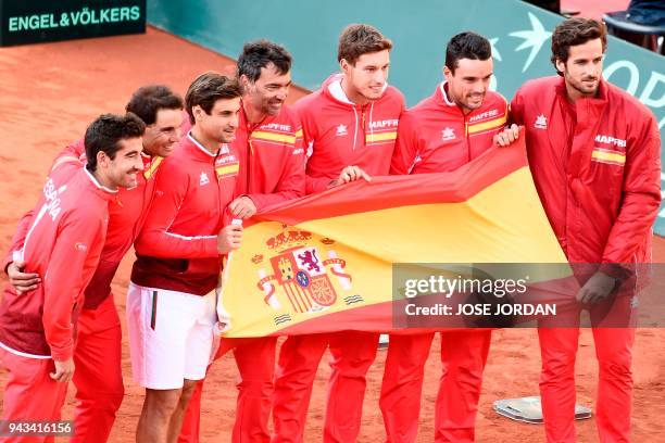 Spain's Marc Lopez, Rafa Nadal, David Ferrer, captain Sergi Bruguera, Pablo Carreno-Busta, Roberto Bautista and Feliciano Lopez celebrate after...